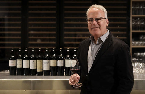 Wine critic, James Suckling, posing with red wines