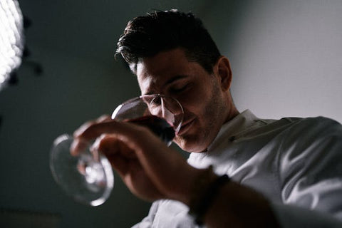 Negociant sniffing red wine