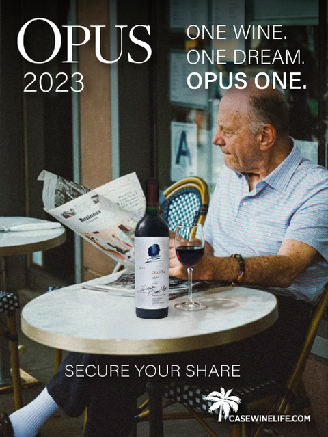 Businessman enjoying Opus One Red Blend while reading newspaper